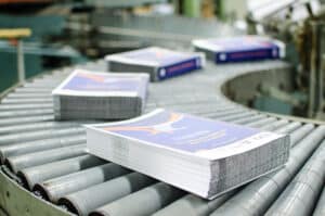 Business printing book blocks traveling on a conveyor