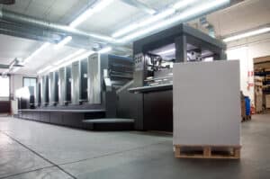 Heidelberg sheet fed offset printing press with a skid of paper waiting to be loaded