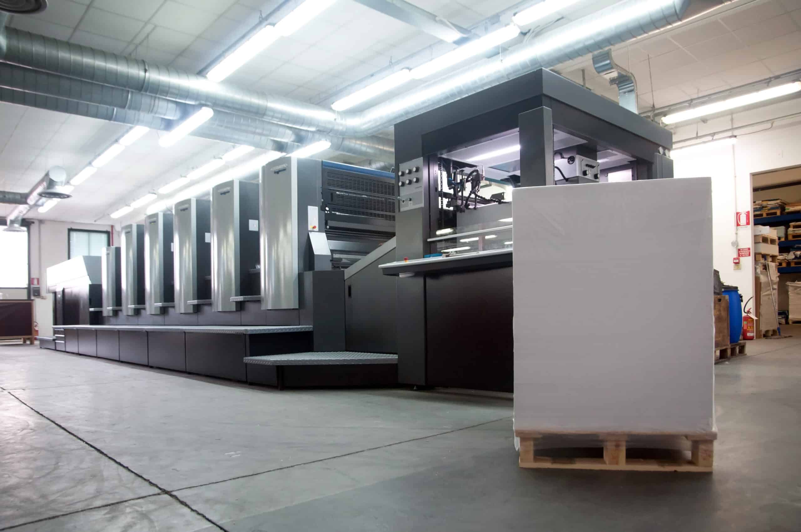 Heidelberg sheet fed offset printing press with a skid of paper waiting to be loaded